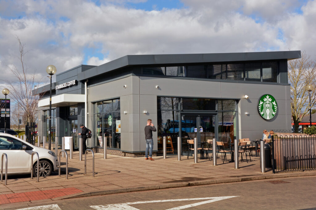 Starbucks Coffee unit with outdoor seating at The Place Retail Park