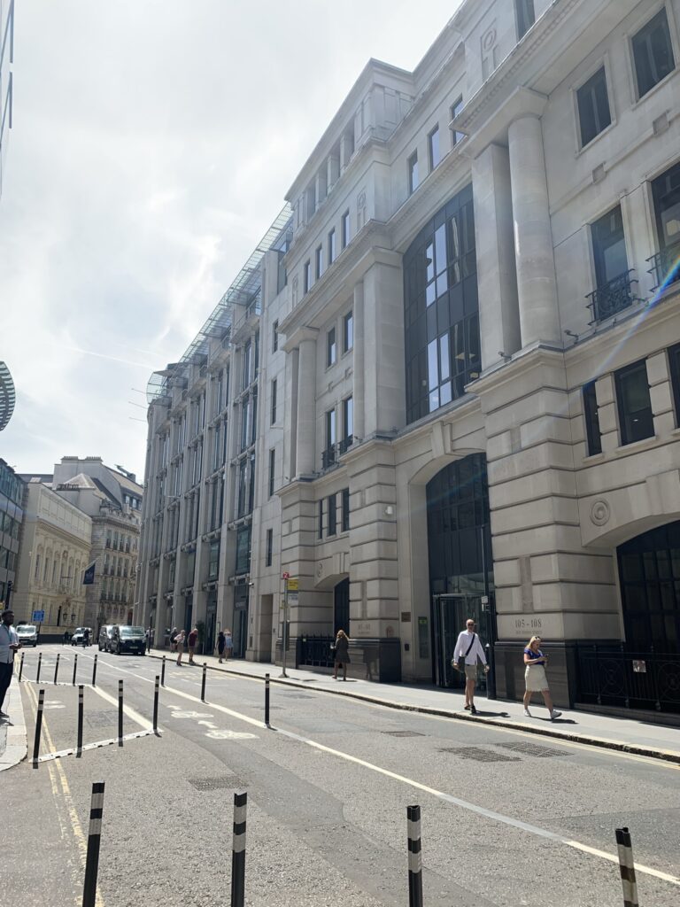 Street view of Pinners Hall on Old Broad Street, London, with pedestrians passing the building